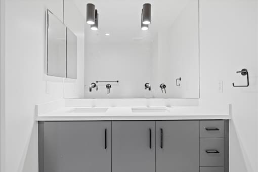 A bathroom with a sink and mirror.
