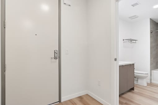 A white bathroom with a toilet and a walk-in shower.