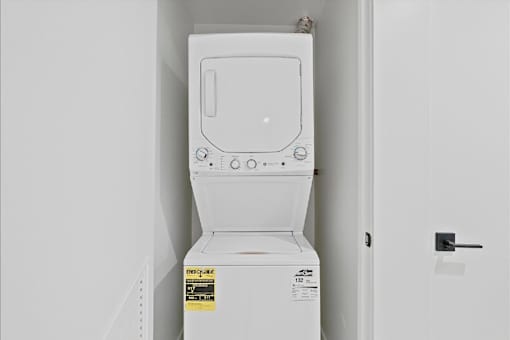 A white toilet with a sticker on the side is in a room.