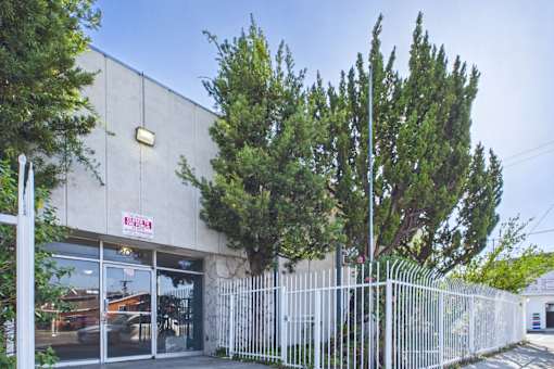 A building with a white fence in front of it.