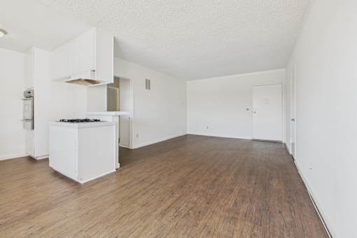 A kitchen with a white cabinet and a white fridge.