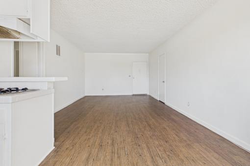 A room with wooden floors and white walls.