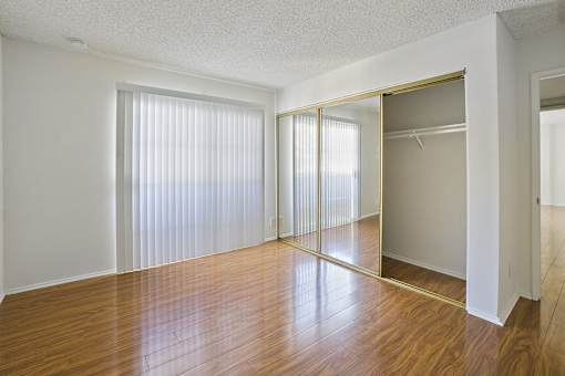 A room with a wooden floor and a sliding door.