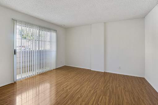 Empty room with wooden floor and white walls.
