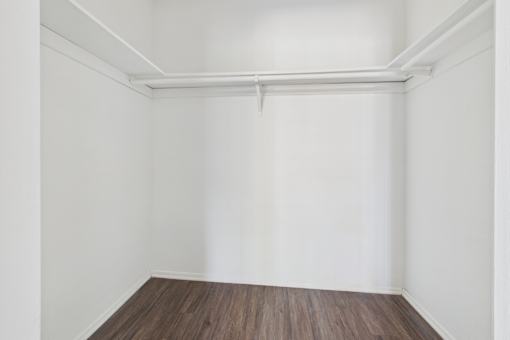 A room with white walls and a wooden floor.