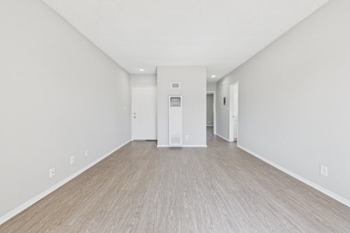 A room with a white door and a white cabinet.
