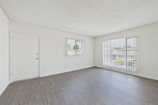 A room with a white door and a window with blinds.