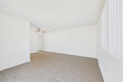 A room with a ceiling fan and light fixture.