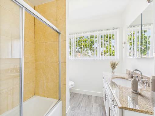 A bathroom with a walk-in shower and a sink.