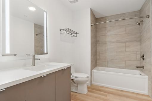 A white bathroom with a toilet, sink, and bathtub.