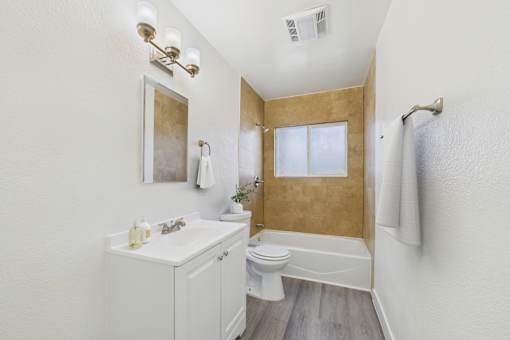 A bathroom with a white sink and toilet.