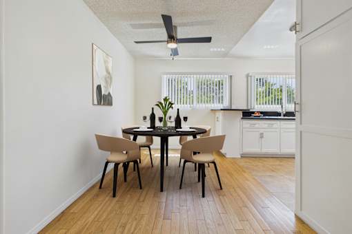 A dining room with a table and chairs.