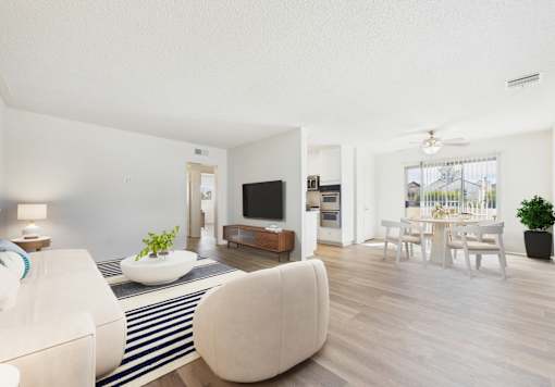 A modern living room with a white sofa and a television.