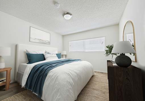 A bedroom with a bed, nightstand, and lamp.
