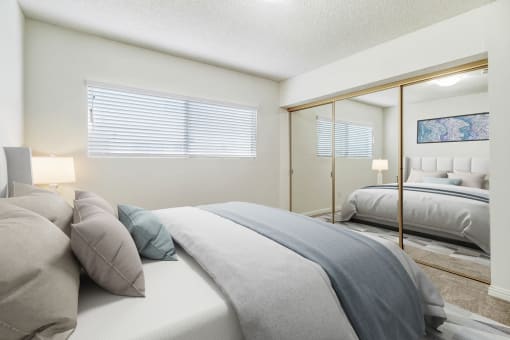 a bedroom with two beds and a mirror