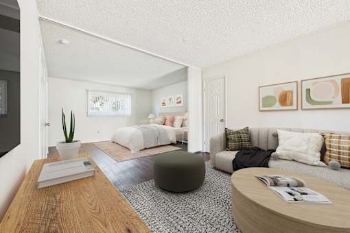 A living room with a grey couch and a green ottoman.