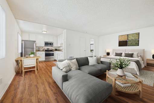 A modern living room with a grey couch and a wooden coffee table.