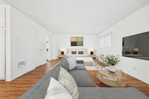 A living room with a grey couch and a coffee table.