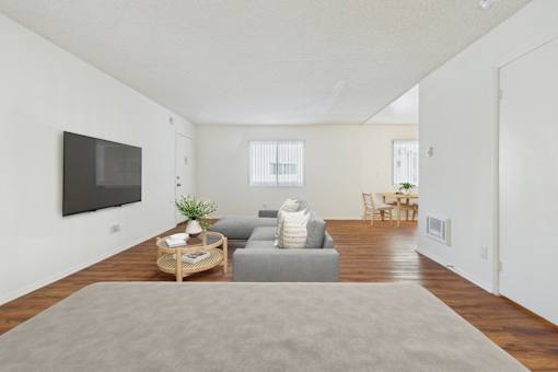 A living room with a grey couch and a wooden coffee table.