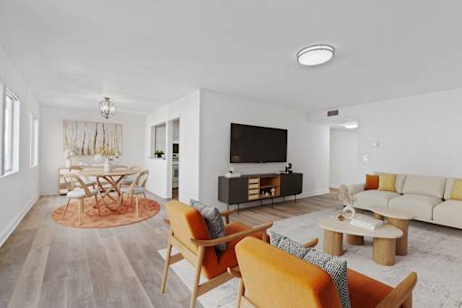 A living room with a television, a sofa, and a coffee table.