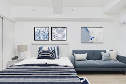 A bedroom with a bed and a couch.