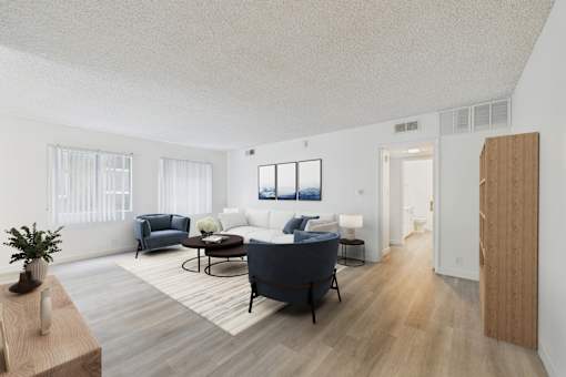 A living room with a blue sofa and a wooden floor.