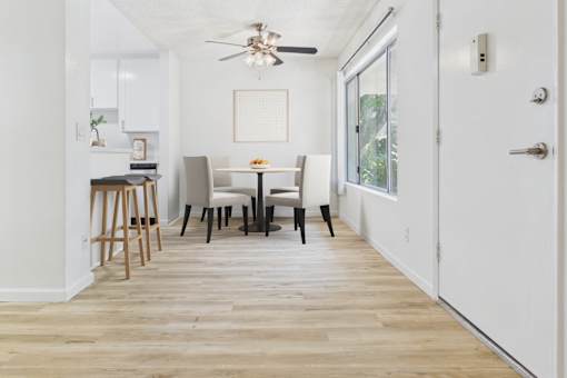 A dining room with a table and chairs.