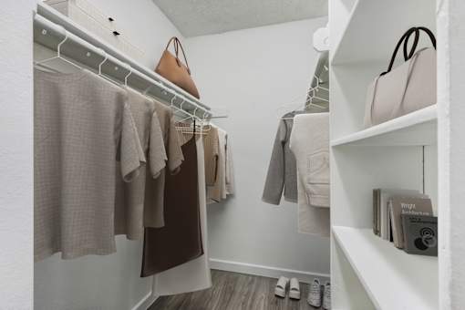 Clothes hanging on a rack in a room.