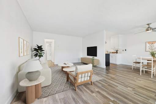 A living room with a white couch, a wooden coffee table, and a grey floor lamp.