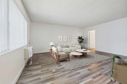 A living room with a white couch and a wooden coffee table.