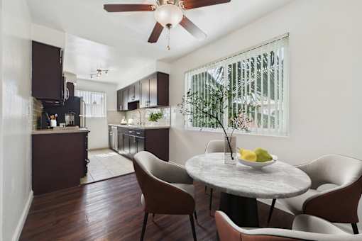 A dining room with a table and chairs.