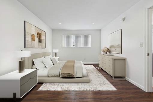 A bedroom with a bed, nightstand, and a dresser.
