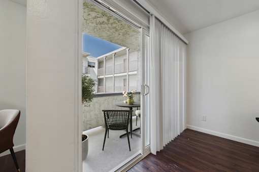 A chair and table are set up on a balcony.