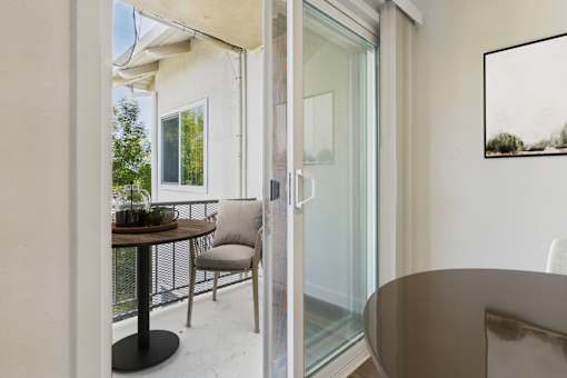A modern dining area with a glass table and chairs.