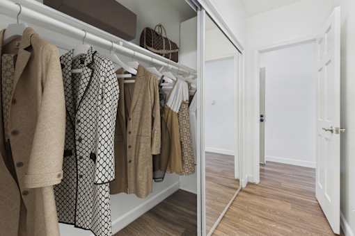 Clothes hanging on a rack in a room.