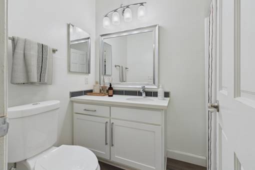 A white bathroom with a toilet, sink, and bathtub.