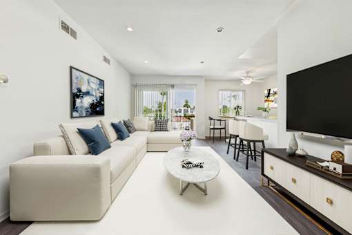 A modern living room with a white sofa and a coffee table.