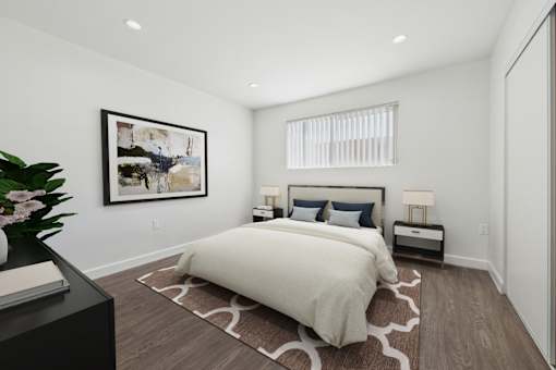 A bedroom with a large bed and a painting on the wall.