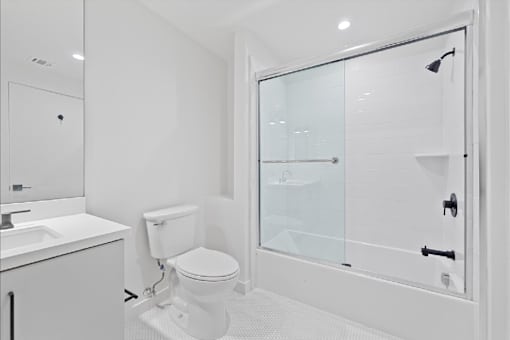 A white toilet sits next to a sink in a bathroom.