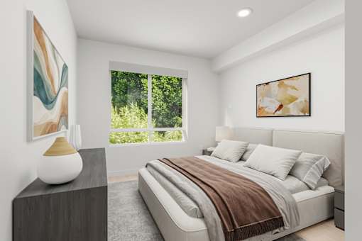 A bedroom with a large bed and a painting on the wall.