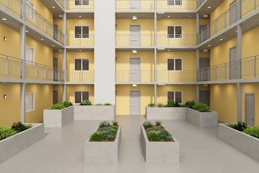 A modern apartment complex with balconies and planters in the courtyard.