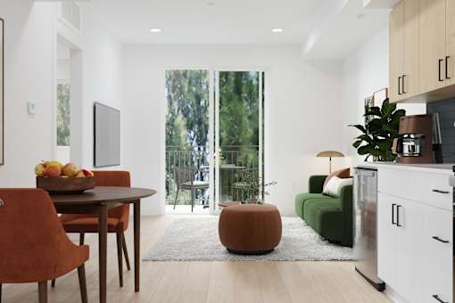 A modern kitchen with a dining table and chairs.