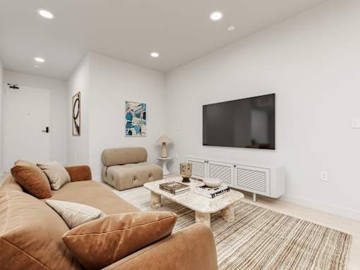 A living room with a brown couch and a white coffee table.