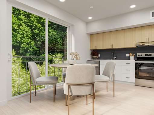 A modern kitchen with a dining table and chairs.