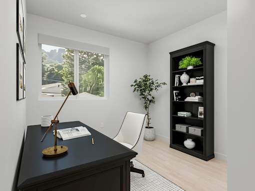 A black desk with a lamp and a chair in front of a window.