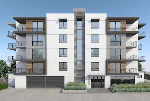 A modern apartment building with balconies and garages.