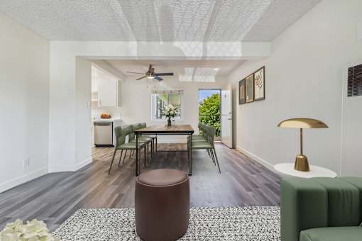 A living room with a brown ottoman and a green couch.