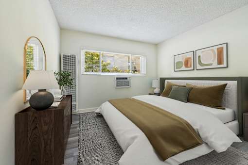 A bedroom with a large bed and a lamp on a wooden stand.