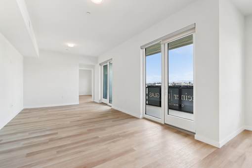 A room with a wooden floor and white walls.