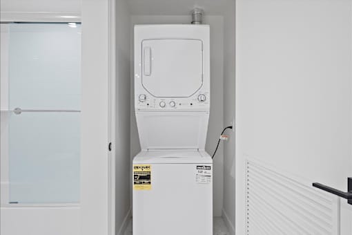 A white tankless water heater in a room.